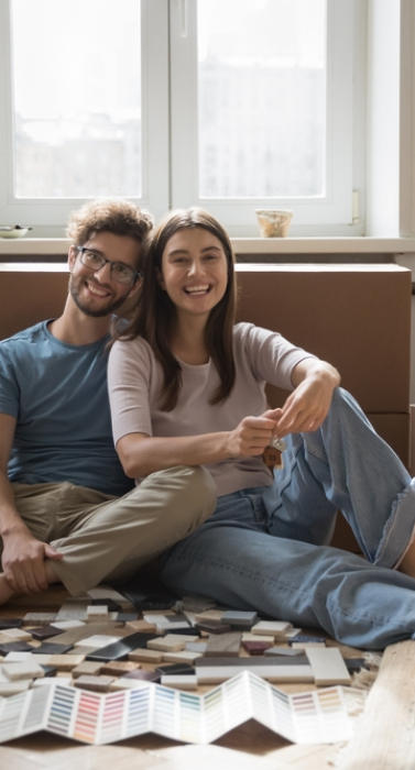 Portrait,Of,Happy,Young,Homeowner,Family,Sit,On,Floor,With